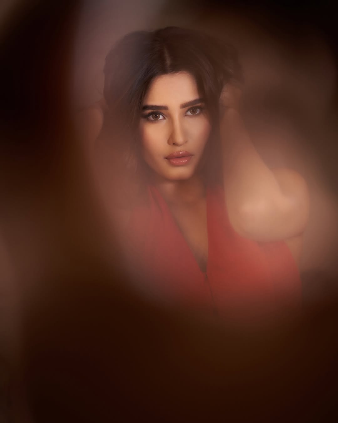 Rasha Thadani red dress blurry image